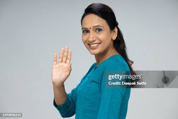 portrait of mid adult woman - stock photo - waving goodbye stock pictures, royalty-free photos & images