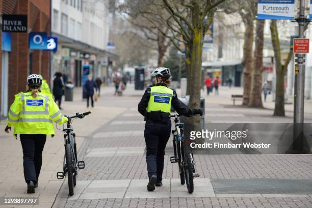 Police are seen patrolling around the city centre on December 31, 2020 in Portsmouth, England. From Thursday, three-quarters of the population of...