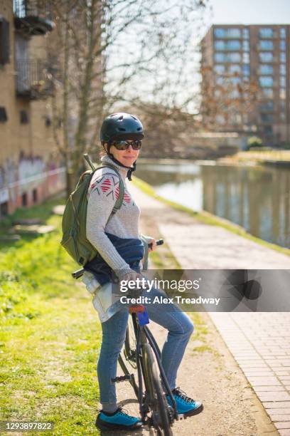 a woman cycling near the regents canal in london - 41 conduit street stock pictures, royalty-free photos & images