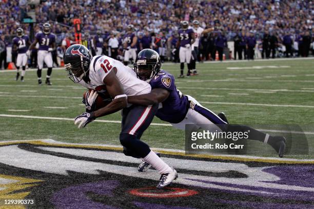 Wide receiver Jacoby Jones of the Houston Texans catches a touchdown pass in front of defender Ed Reed of the Baltimore Ravens during the second half...