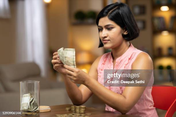 young woman - stock photo - calculating money stock pictures, royalty-free photos & images