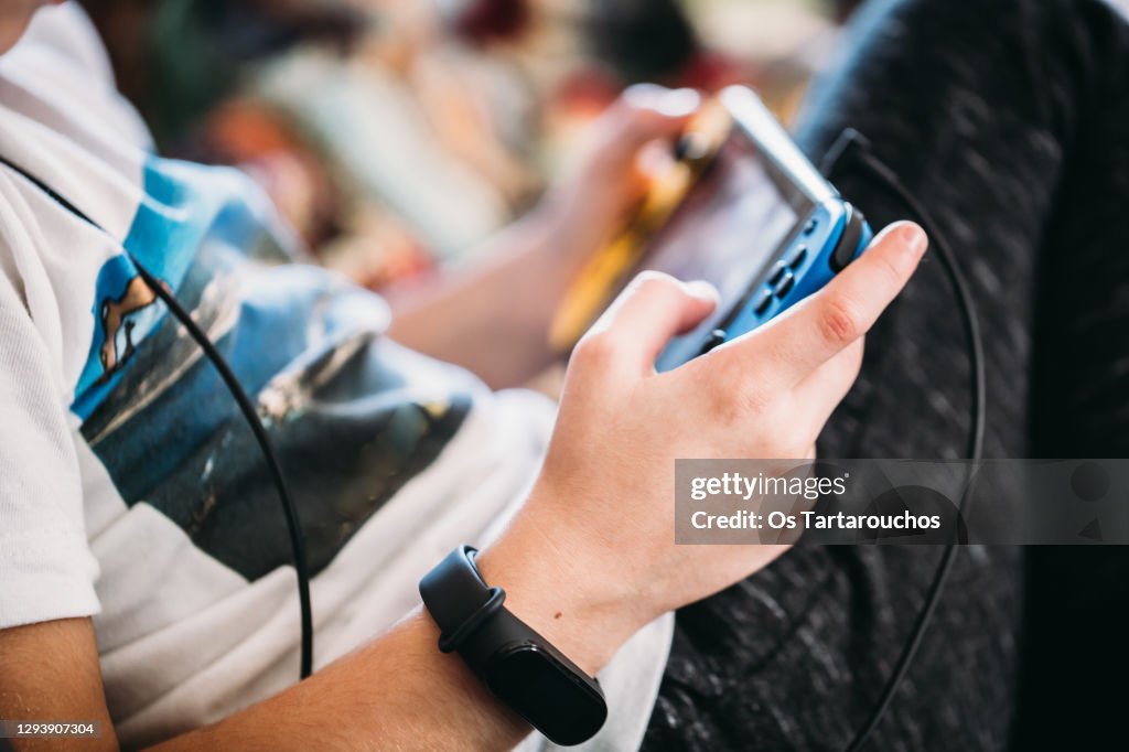 Close up of boy hands with a smart watch playing videogames