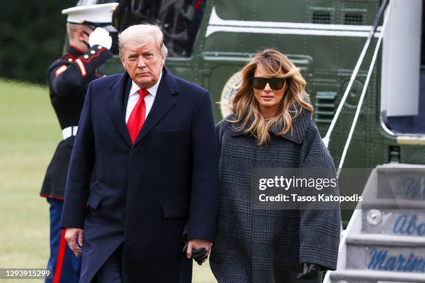 President Donald Trump and First Lady Melania Trump depart Marine One on the South Lawn of the White House on December 31, 2020 in Washington, DC....