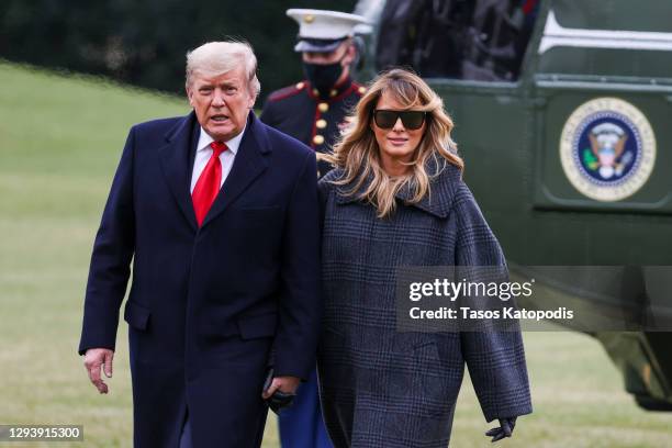 President Donald Trump and First Lady Melania Trump depart Marine One on the South Lawn of the White House on December 31, 2020 in Washington, DC....