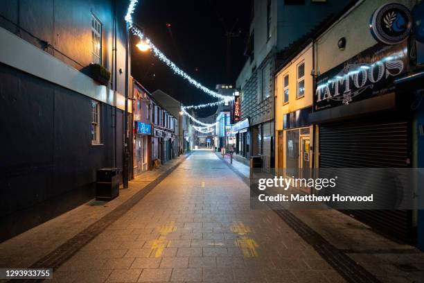 An empty Caroline Street in central Cardiff on December 31 in Cardiff, Wales. Wales went into a Level 4 lockdown from midnight on December 19. All...