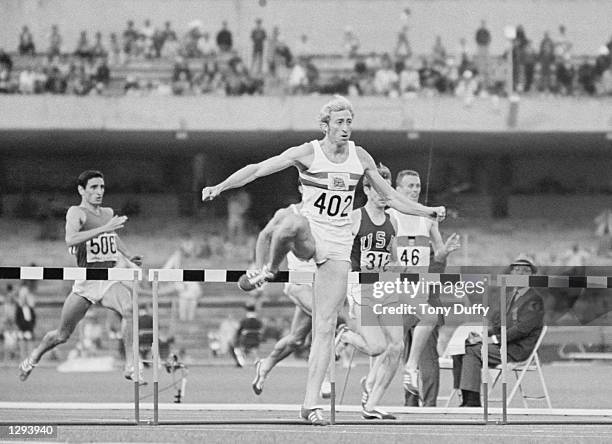 David Hemery of Great Britain leads the field during the 400 metres Hurdles event at the 1968 Olympic Games in Mexico City. Hemery won the gold...