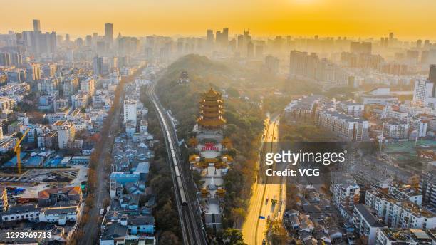 Aerial view of the Yellow Crane Tower and buildings at sunrise on New Year's Day on January 1, 2021 in Wuhan, Hubei Province of China.