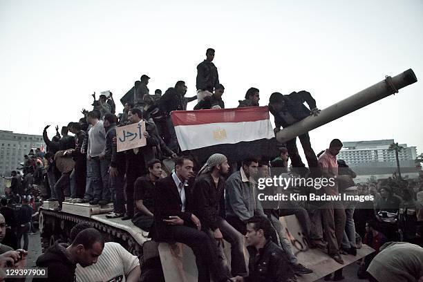 Peaceful demonstrators climb onto a Egyptian army tank in Tahrir Square on January 29, 2011 in Cairo, Egypt.