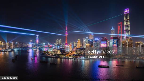 Buildings at the Lujiazui Financial Centre are illuminated during a light show as part of New Year's Eve celebrations on December 31, 2020 in...