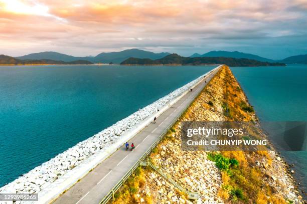 aerial view of road of the reservoir dam - flood city stock pictures, royalty-free photos & images