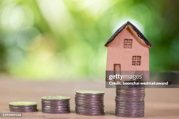 mortgage concept. money and house - coin photos fotografías e imágenes de stock