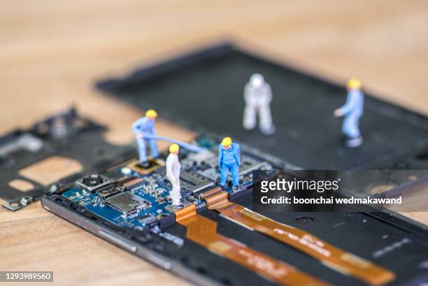 miniature worker, technician repairing mobile repairer - computer repair background stock pictures, royalty-free photos & images