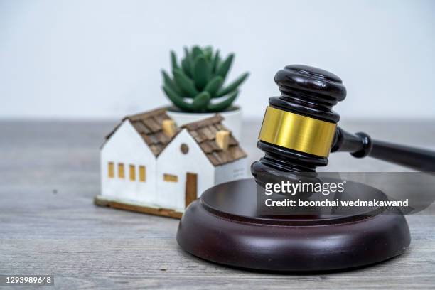 house with gavel. real estate law and house auction concept. - auction stock pictures, royalty-free photos & images