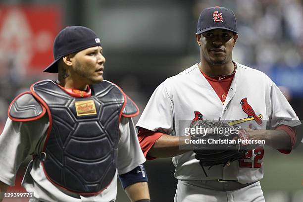 Catcher Yadier Molina and starting pitcher Edwin Jackson of the St. Louis Cardinals walk across the field from the bull pen for prior to the start of...