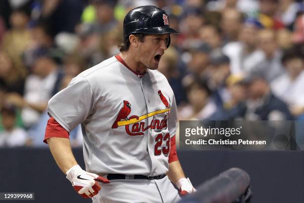David Freese of the St. Louis Cardinals celebrates after he hit a 3-run home run in the top of the first inning against the Milwaukee Brewers during...