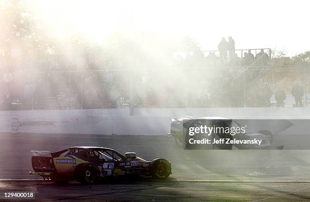 Tom Rogers, driver of the MissMarianaLee.com Chevrolet and Gary McDonald, driver of the Lakeland Landscape/TRC Electric Chevrolet spin during the...