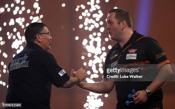Gary Anderson of Scotland and Dirk van Duijvenbode of The Netherlands congratulate each other after there Quarter Finals match against during Day...