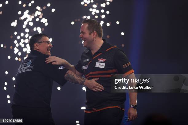 Gary Anderson of Scotland and Dirk van Duijvenbode of The Netherlands congratulate each other after there Quarter Finals match against during Day...