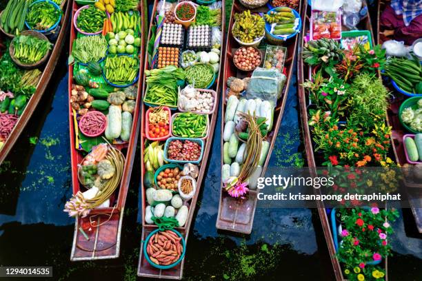 floating market on a canal in thailand,vegetables and fruit - floating market stockfoto's en -beelden