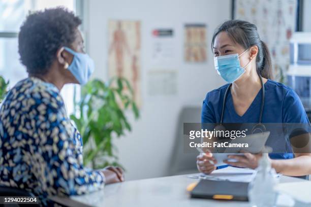 asian female doctor meeting patient - visit stock pictures, royalty-free photos & images