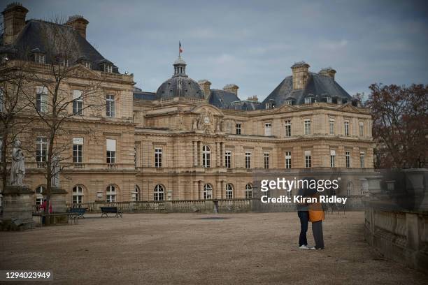 Couple embrace at Luxembourg Gardens on New Years Day on January 01, 2021 in Paris, France. New Year's eve celebrations and fireworks were cancelled...
