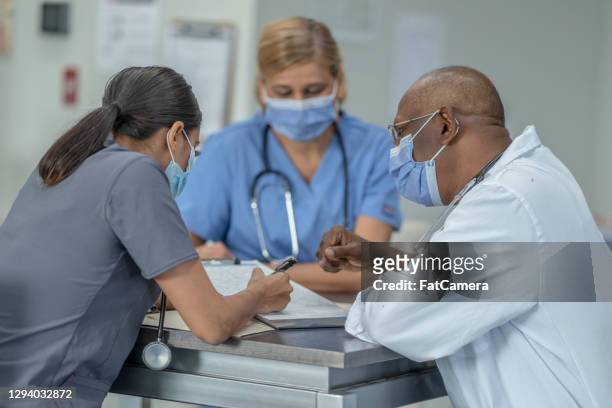 group of healthcare workers meeting - group of people wearing masks stock pictures, royalty-free photos & images