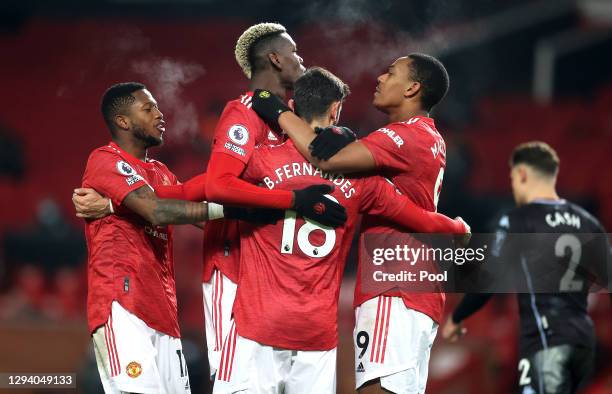 Bruno Fernandes of Manchester United celebrates with teammates Fred, Paul Pogba and Anthony Martial after scoring their team's second goal during the...