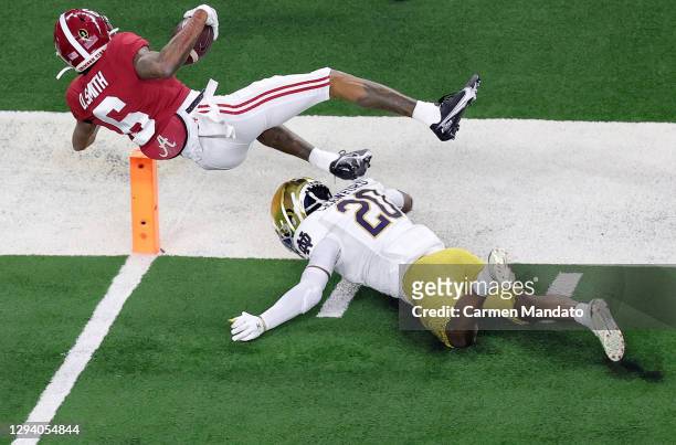 Wide receiver DeVonta Smith of the Alabama Crimson Tide dives over safety Shaun Crawford of the Notre Dame Fighting Irish for a touchdown in the...
