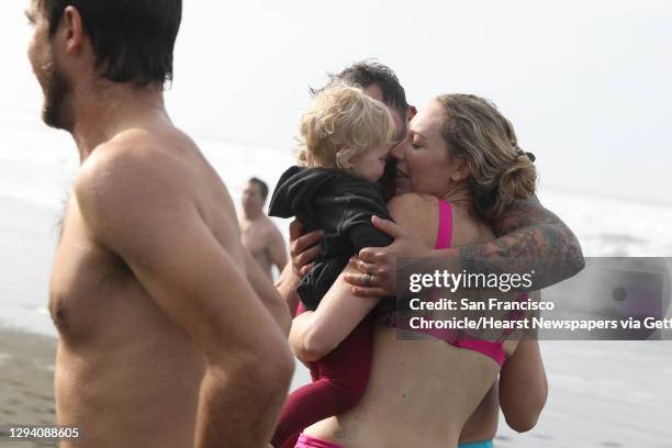 Jackie Jacobs of San Francisco and Steven Jacobs greet and embrace their daughter Islay Jacobs, 18 months, after Jackie and Steven plunged into the...