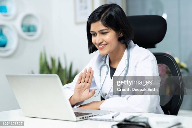 portrait of female doctor working in clinic stock photo - virtual medicine stock pictures, royalty-free photos & images