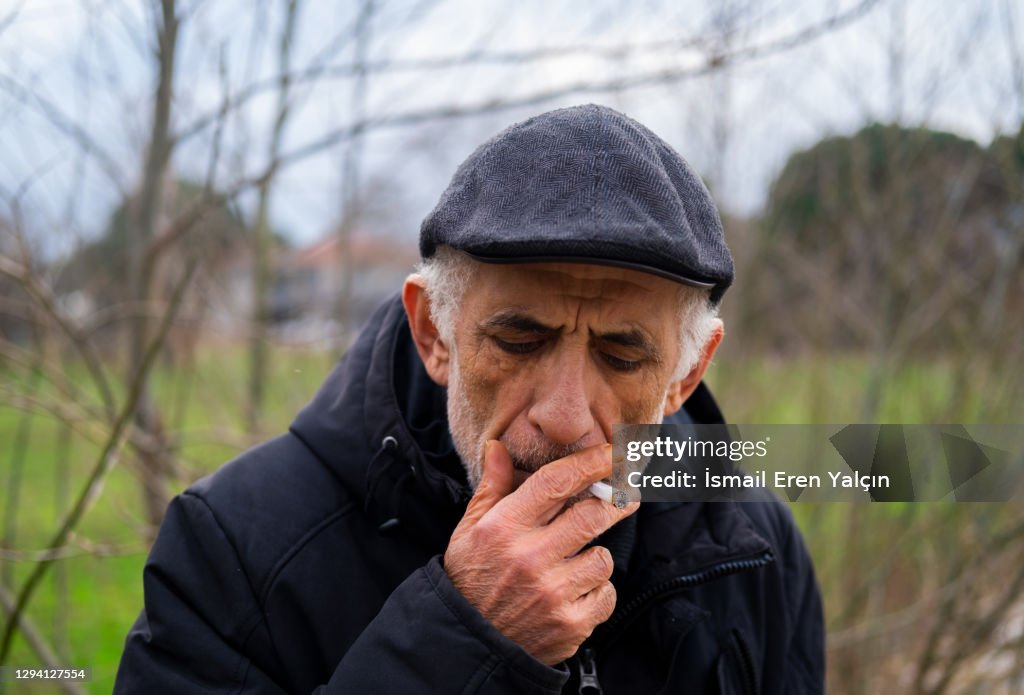 Old man who smokes tobacco