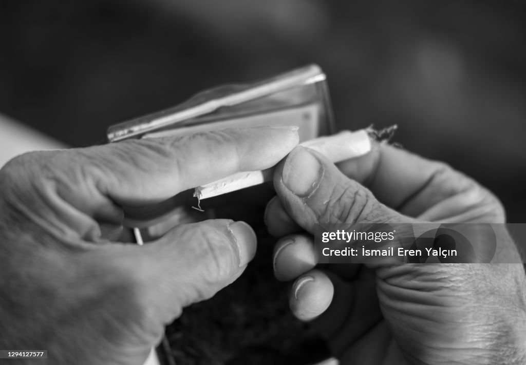 Old man who smokes tobacco