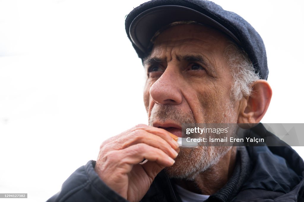Old man who smokes tobacco