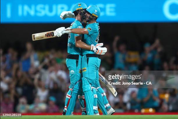 Jack Wildermuth and Lewis Gregory of the Heat celebrate the win during the Big Bash League match between the Brisbane Heat and the Sydney Sixers at...