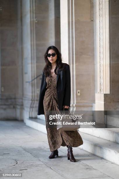 Fashion blogger Xiayan wears sunglasses from Bottega Veneta, a black oversized blazer jacket from Les Coyotes de Paris, a brown gathered leopard...