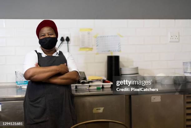 african female kitchen working wearing mask in commercial kitchen - small business mask stock pictures, royalty-free photos & images