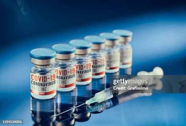 covid-19 vaccine in small bottle with syringe - sputnik stock pictures, royalty-free photos & images