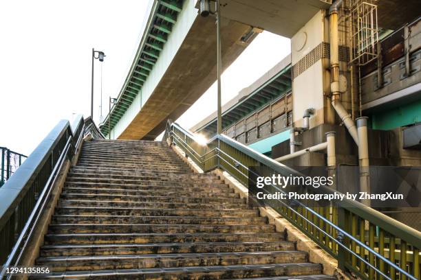 outdoor stairs with junction in tokyo, japan. - tsukishima tokio stockfoto's en -beelden
