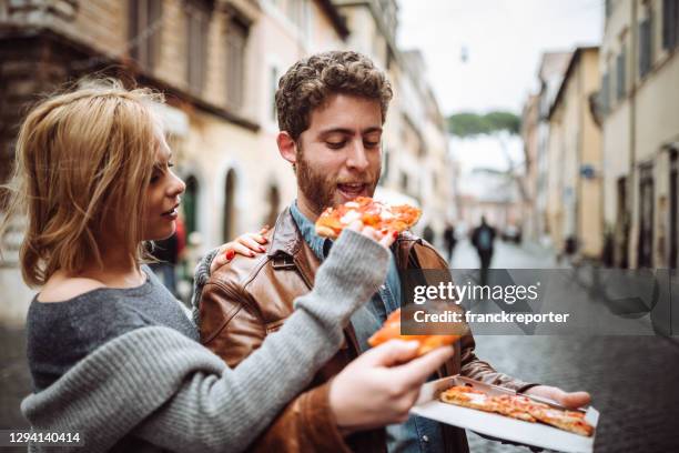 friends eating pizza in italy - eating fast food stock pictures, royalty-free photos & images