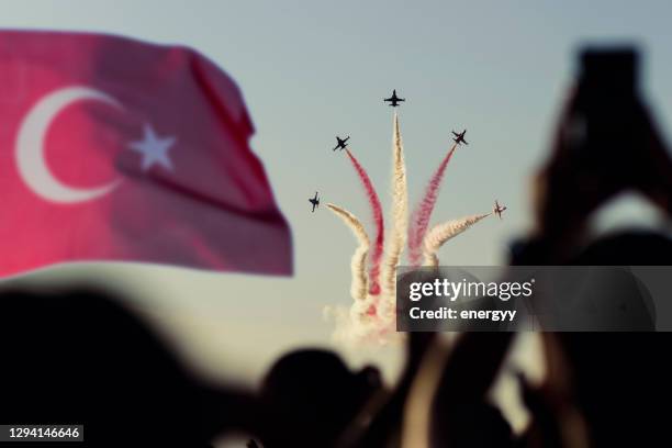 unrecognizable people taking pictures by watching a plane show - turkish army stock pictures, royalty-free photos & images