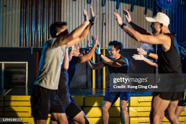 asian multi ethic group of people happy and high five after complete the training course. - obstacle course stock pictures, royalty-free photos & images