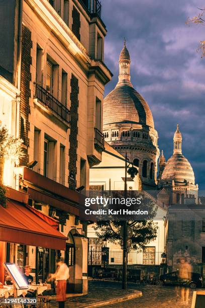 a dusk view of montmartre in paris, france - stock photo - church color light paris stockfoto's en -beelden