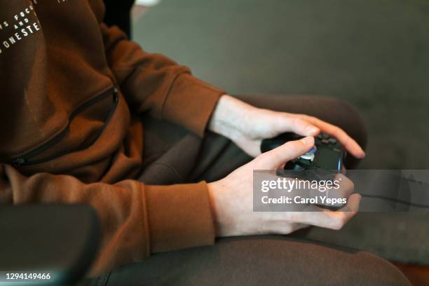 close up of  boy holding game controller - gamepad stock pictures, royalty-free photos & images