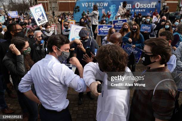 Democratic U.S. Senate candidate Jon Ossoff greets a supporter during a campaign stop outside Athens-Clarke County City Hall January 2, 2021 in...