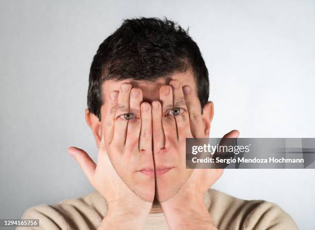 composite portrait of a serious man with his hands covering his eyes and face as in see no evil - can't see the wood for the trees stock pictures, royalty-free photos & images