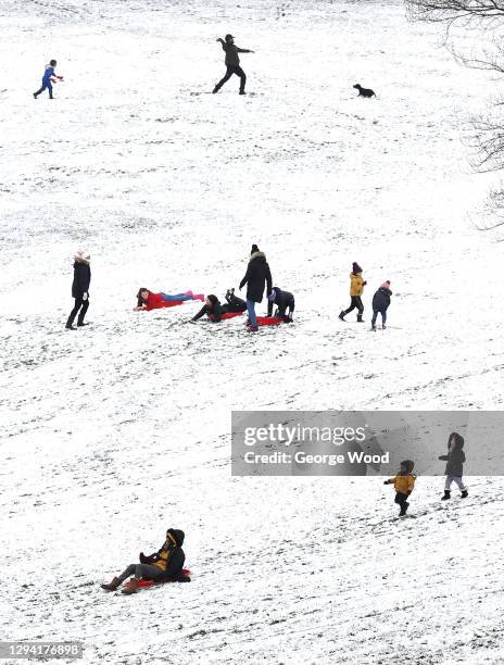 People go sledging in the snow around Peel Park on January 02, 2021 in Bradford, United Kingdom.
