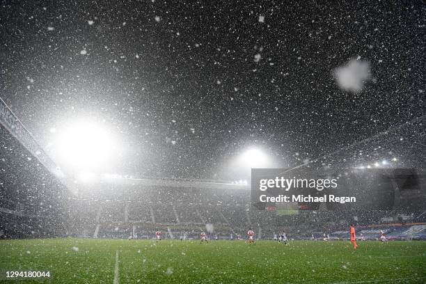 General view inside the stadium as snow falls during play during the Premier League match between West Bromwich Albion and Arsenal at The Hawthorns...