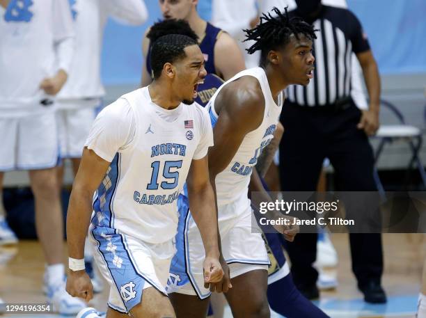 Garrison Brooks and Day'Ron Sharpe of the North Carolina Tar Heels react after taking the lead late in the second half of their game against the...
