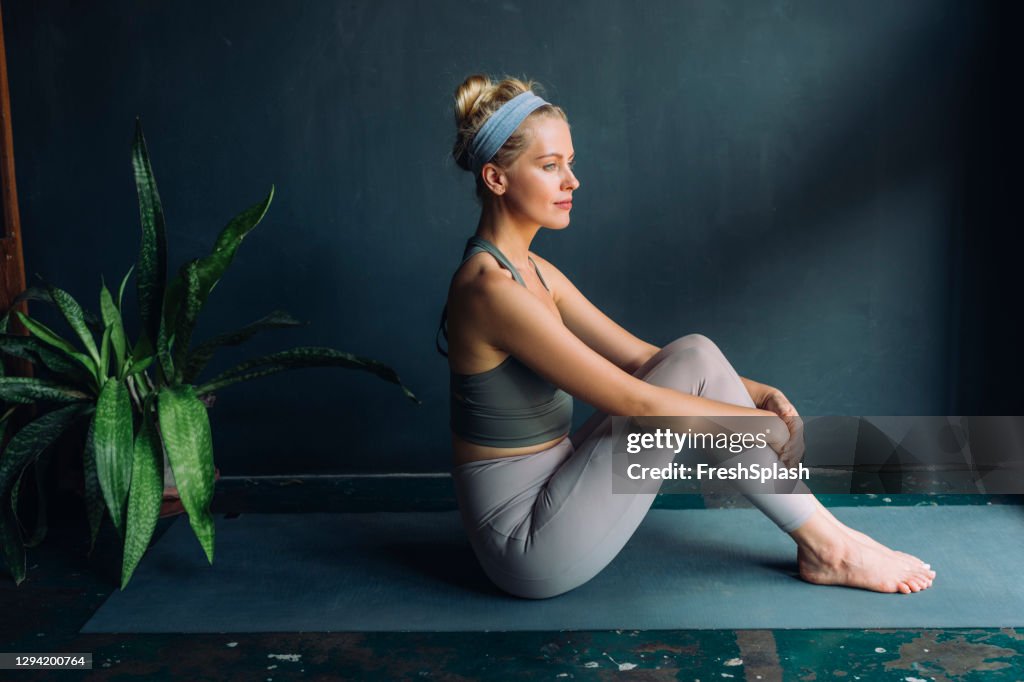 Self Care Rituals: Beautiful Fit Blonde Woman Doing Yoga at Home