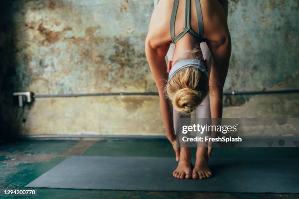 lockdown concept: anonymous blonde woman stretching at her home - toe stock pictures, royalty-free photos & images